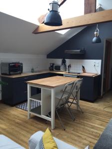 a kitchen with a table and chairs in a room at Lannion city center apartment in Lannion