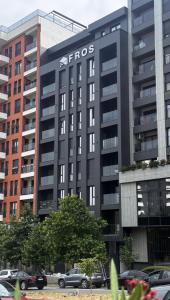 a syros building with cars parked in front of it at Oakline Apartments in Pristina +23 photos