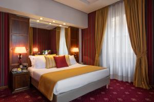 a hotel room with a large bed and a window at Atlante Garden Hotel in Rome