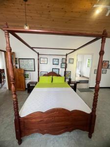 a bedroom with a bed with a wooden frame at Rice field Retreat in Minuwangoda