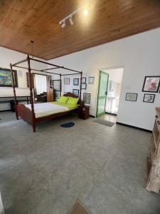 a bedroom with a canopy bed in a room at Rice field Retreat in Minuwangoda