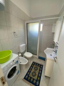 a bathroom with a washing machine and a sink at Nana Dea 2 in Utjeha +23 photos