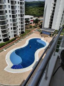 a view of a swimming pool from the balcony of a building at Apartamento Conjunto Aqualina Orange in Girardot
