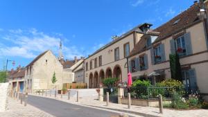 a street in a small town with buildings at Les échappées de Senonches in Senonches