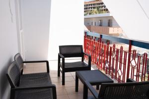a balcony with chairs and tables on a building at G&G Luxury Rooms in Bari