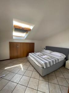 een slaapkamer met een bed en een dakraam bij Nico's apartment in Sirmione +17 foto's