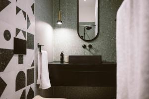 un bagno con lavandino e specchio di SoulNest Apartments a Sarajevo Altre 24 foto