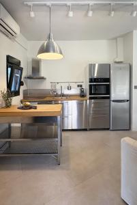 a large kitchen with stainless steel appliances at Nikiti Blue house 30m from the beach with sea view in Nikiti