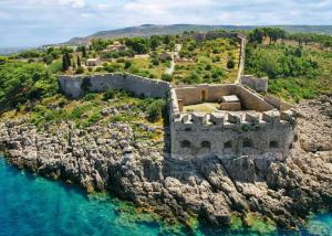 an old castle on a rocky island in the water at Pylos Sunset Retreat with Panoramic Sea Views in Pylos