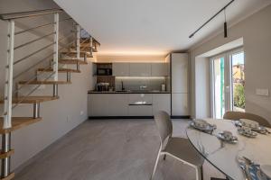a kitchen and dining room with a staircase and a table at BLUE RESIDENCE - Relax e vista da sogno in Pieve Ligure