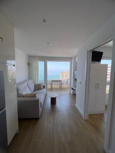 a living room with a couch and a view of the ocean at Apartamento Centro Internacional Torrox Costa in Torrox Costa