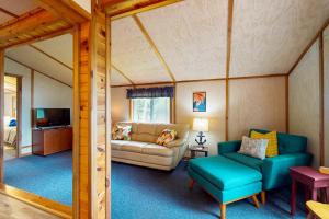a living room with a couch and a chair at Catfish Cottage B in Eagle River