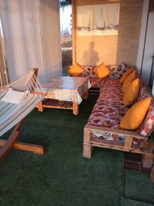 a living room with two beds and a hammock at Appartement à Prestigia Plage des nations salé in Sale