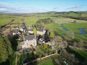 an aerial view of a large house in a field at Pass the Keys The Old Shop Family Cottage for 6 & Furry Friends in Hulme End
