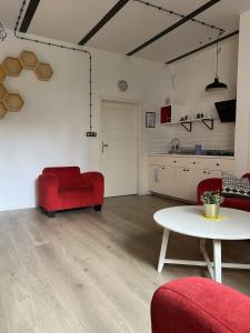 a living room with a red couch and a table at SPOKO Hostel in Gdańsk +55 photos