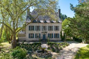 an old house with a garden in front of it at French Manor House with private gardens and pool in Foissac