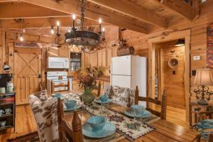 a dining room with a table and a white refrigerator at Falcon Lodge - hot tub fire pit & games in Mentone +41 photos