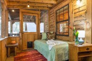 a bedroom with a bed in a log cabin at Falcon Lodge - hot tub fire pit & games in Mentone