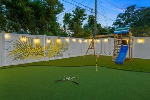 a playground with a slide and a play structure at Slashin' Staycation Pool Putt Putt Kids Playground in Seminole