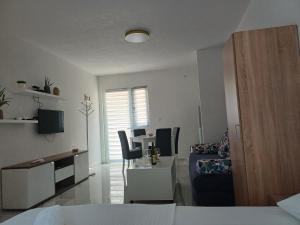 a living room with a bed and a table and chairs at Apartment Brijest-Kotor in Kotor