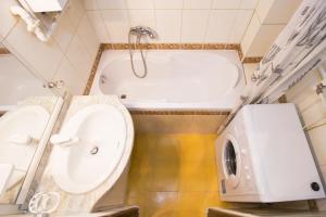 a bathroom with a tub and a toilet and a sink at Apartment Ve Smeckach with a big Terrace in Prague