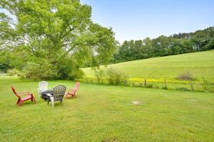 two chairs and a table in a field at Country Lane Cottage- privacy & quiet neighborhood in Rossville