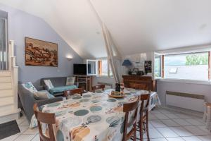a dining room and living room with a table and chairs at Chalet cosy Vallée d’Aspe in Accous