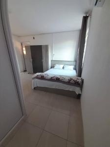 a bedroom with a bed in the middle of a room at Modern Villa near the Beach in Pereybere
