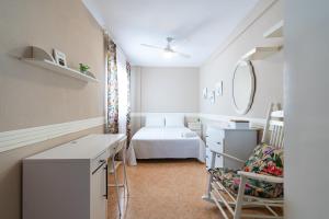a white room with a bed and a chair at Casa Moraira - By Aloha Palma in Águilas +33 photos