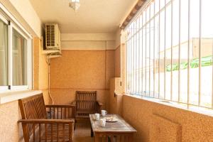 a table and chairs in a room with a window at Casa Moraira - By Aloha Palma in Águilas