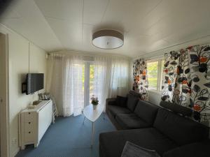 a living room with a couch and a table at Gäststuga i mysiga Sparreholm in Sparreholm