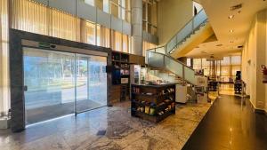 a store with a glass door and a shelf of wine bottles at Quarto Mobiliado no Hotel Go Inn Taguatinga com Wi-Fi, Ar Condicionado e Estacionamento Grátis in Brasília