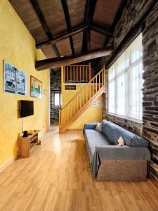 a living room with a couch and a staircase at 39A01 La Casita Olga Casa en plena naturaleza in Arrojo