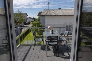 a patio with a table and chairs on a balcony at Villa Andrea Apartments - Ljubljana in Ljubljana