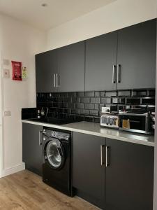 a kitchen with a washing machine in a kitchen at Foundry Street Apartment 1 - Dunfermline City Centre in Dunfermline