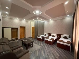 a living room with two couches and a tv at Olympic Hotel Gyumri in Gyumri +50 photos