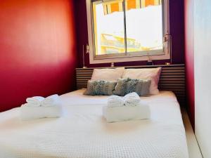 a bedroom with a bed with two towels on it at joli T2 central rénové in Menton