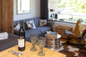 a bottle of wine sitting on a table with two glasses at Ferienwohnung der Berg ruft in Sankt Andreasberg