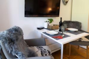 a white table with a bottle of wine on it at Ferienwohnung der Berg ruft in Sankt Andreasberg