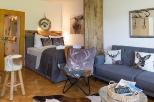 a living room with a bed and a couch at Ferienwohnung der Berg ruft in Sankt Andreasberg
