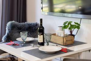 a table with a bottle of wine and glasses on it at Ferienwohnung der Berg ruft in Sankt Andreasberg