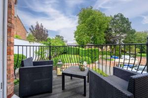 a patio with two chairs and a table on a deck at Luxurious Bowdon Mansion by City SuperHost in Bowdon