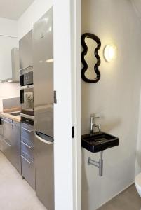 a kitchen with a sink and a refrigerator at Nikiti Blue house 30m from the beach with sea view in Nikiti +57 photos