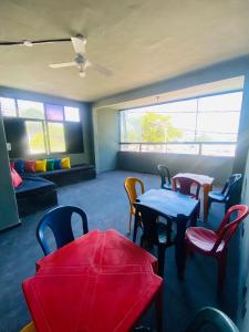 a room with tables and chairs and a couch at Hostel do Meio in Salvador +35 photos