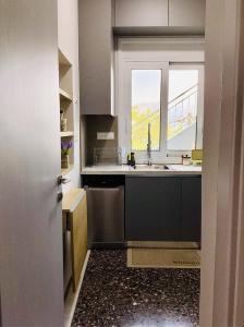 a kitchen with a sink and a window at Sea breeze in Nafpaktos