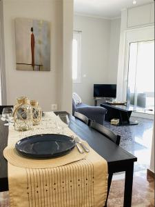 a table with a plate on it in a living room at Sea breeze in Nafpaktos