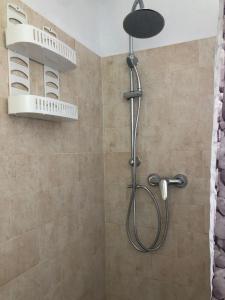 a shower with a shower head in a bathroom at Finca Abril 1 Piscina Compartida in Conil de la Frontera