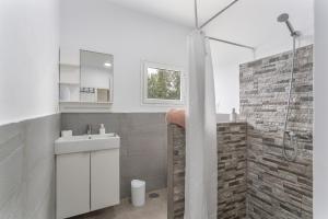 a bathroom with a white sink and a shower at El Cuarto De Moza in Tinajo +36 photos