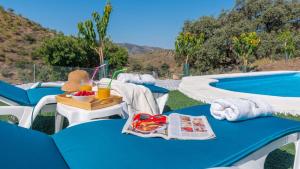 a table with a tray of food next to a swimming pool at Casa Esperanza Sedella by Ruralidays in Sedella