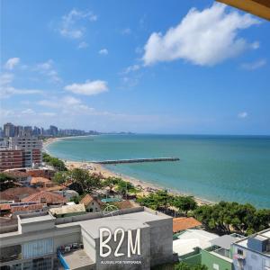 a view of the beach from a building at Amplo apartamento no coração da Cidade, quadra mar in Piçarras